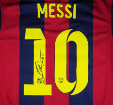 Lionel Messi signing a jersey